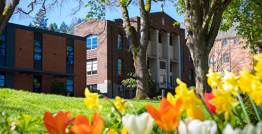 Beautiful flowers bloom in front of Seattle Pacific University's McKinley Hall.