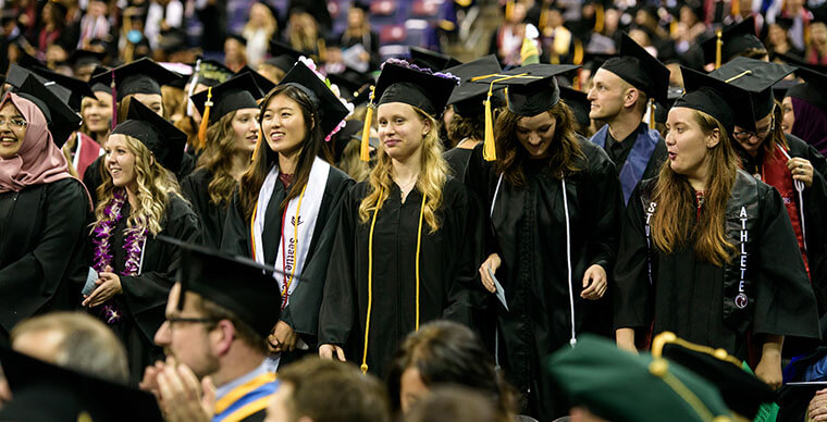 A group of SPU grads in caps and gowns at the 2019 Undergraduate Commencement ceremony