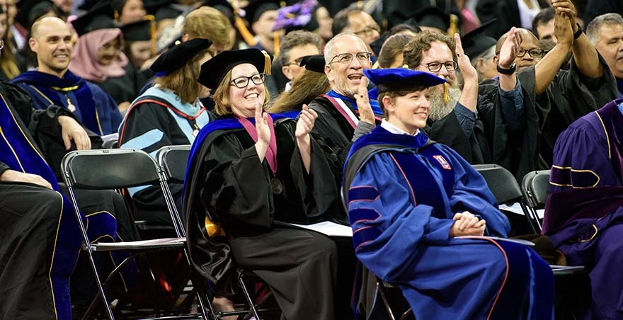 SPU faculty members applaud at the Undergraduate Commencement Ceremony.
