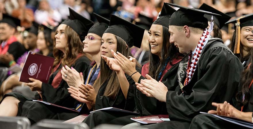 Students clap and smile during the Seattle Pacific University Undergraduate Commencement Ceremony.