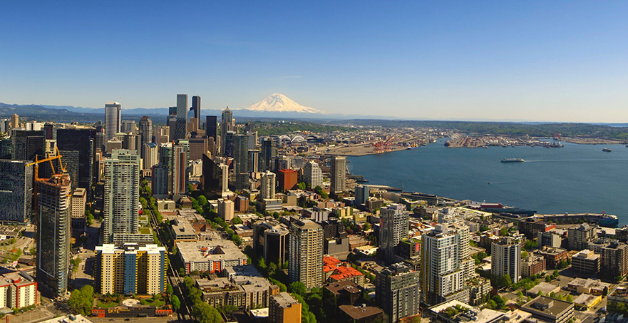 Downtown Seattle with waterfront and view of Mount Rainier