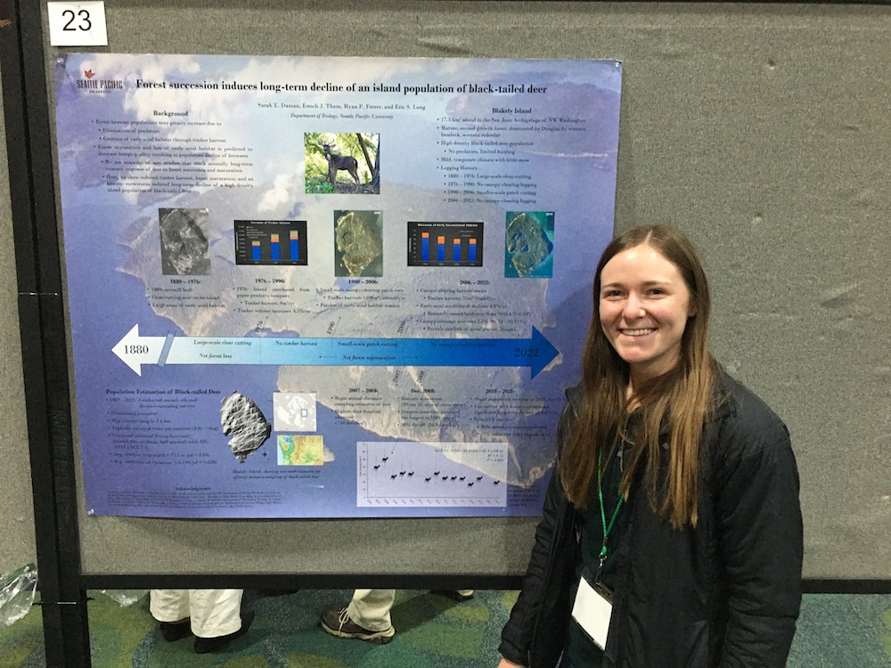 Sarah Daman stands in front of her poster at the annual meeting of The Wildlife Society in Spokane, WA.