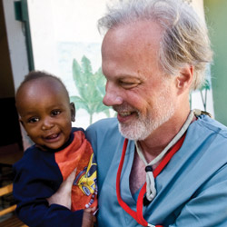 John Thoburn and child in Haiti.