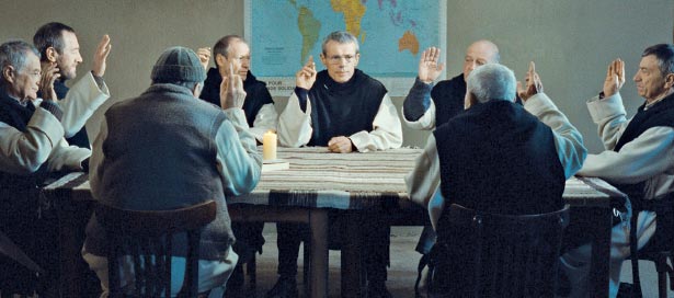 Monks sitting around table