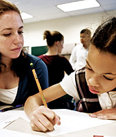 A pre-service teacher works with a young student.