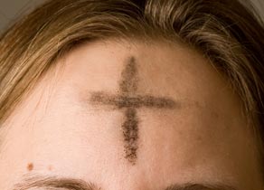A cross of ashes on a worshiper's forehead