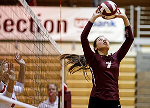 Young woman in action catching a volleyball